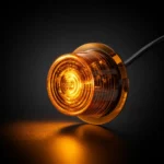 Ronde amber TRALERT LED-module met zwarte behuizing en amber licht